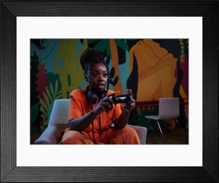 Framed Print : Gamer girl enjoying an intense gaming session Framed Print : Gamer girl enjoying an intense gaming session