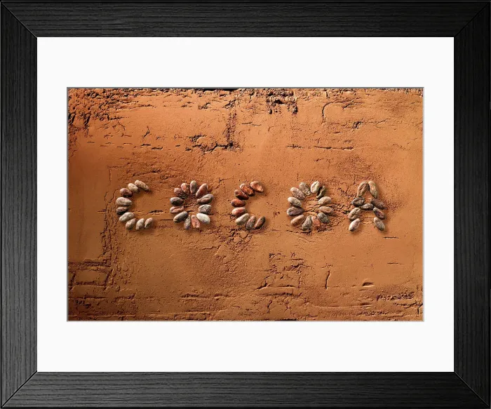Framed Print : Cocoa. The word cocoa written using cocoa beans on surface of powdered cocoa