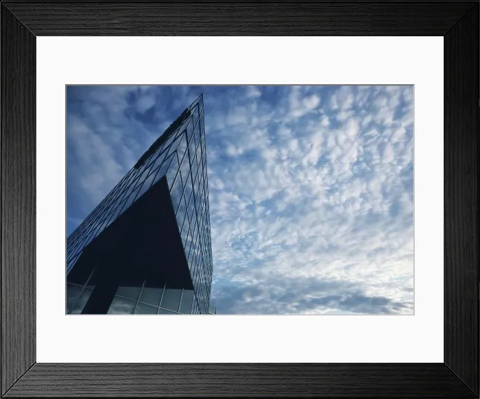 Framed Print : Architectural detail of a skyscraper against cloudy sky Framed Print : Architectural detail of a skyscraper against cloudy sky