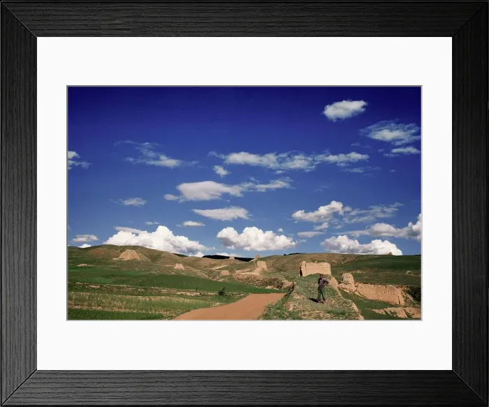 Framed Print : Man standing in front of ruins of Framed Print : Man standing in front of ruins of