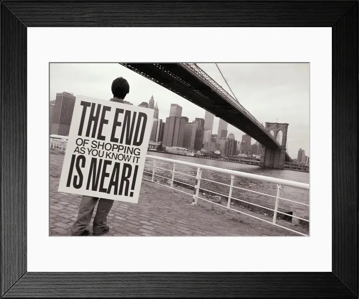 Framed Print : Man wearing placard saying THE END OF SHOPPING AS YOU KNOW IT IS NEAR! and looking out at Manhattan