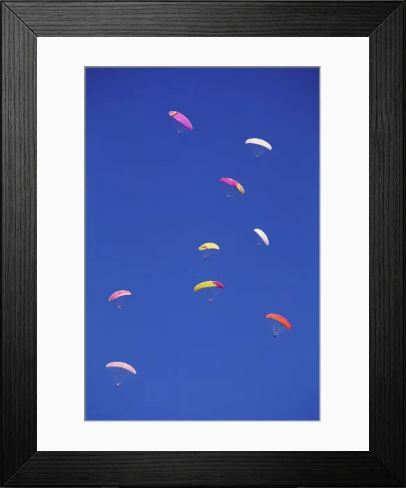 Framed Print : Paragliders paragliding against blue sky Framed Print : Paragliders paragliding against blue sky