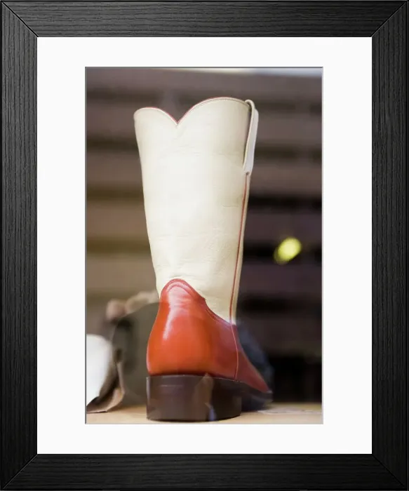 Framed Print : Two-toned cowboy boot in window of a boot shop