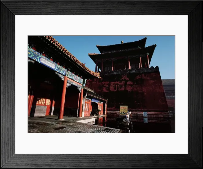 Framed Print : Man riding a bicycle through a pool of water in front of an ancient Chinese building Framed Print : Man riding a bicycle through a pool of water in front of an ancient Chinese building