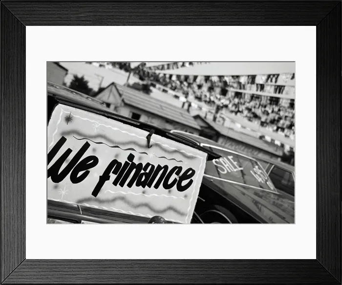 Framed Print : We Finance sign at car dealership