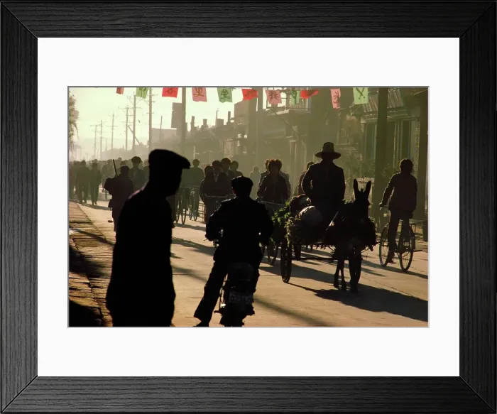 Framed Print : Silhouette of people walking and riding bikes on the street Framed Print : Silhouette of people walking and riding bikes on the street