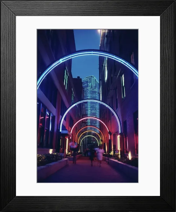 Framed Print : Neon lighted archway in an alley in the West End historical district with Bank of America Building in the background