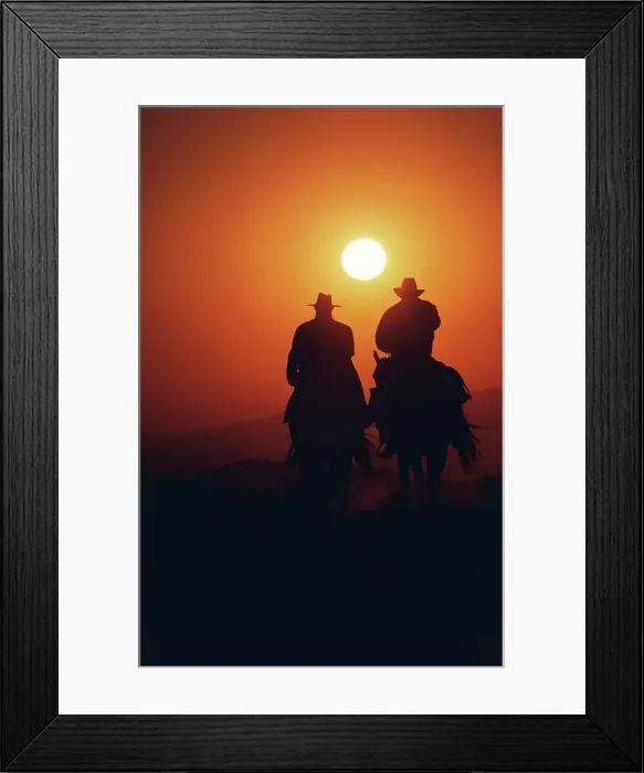 Framed Print : Silhouette of two cowboys riding their horses at sunset Framed Print : Silhouette of two cowboys riding their horses at sunset