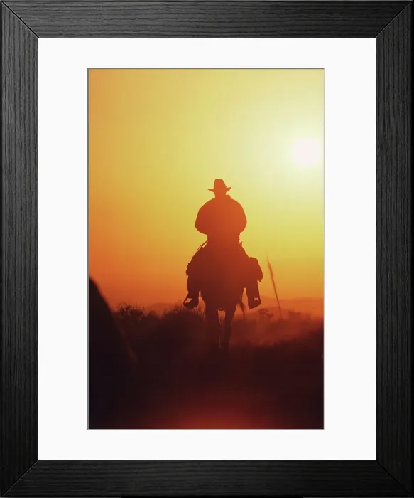 Framed Print : Silhouette of a cowboy riding horse at sunset Framed Print : Silhouette of a cowboy riding horse at sunset