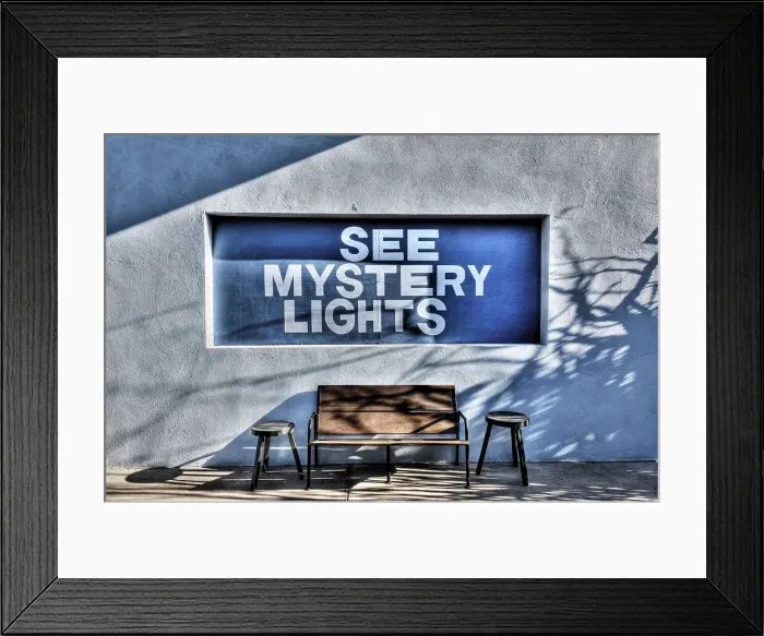 Framed Print : See Mystery Lights sign on a building with a bench and two stools Framed Print : See Mystery Lights sign on a building with a bench and two stools