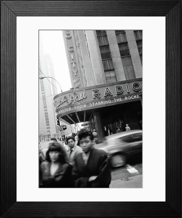 Framed Print : Crowd and traffic moving along the street in front of the Radio City Music Hall Framed Print : Crowd and traffic moving along the street in front of the Radio City Music Hall