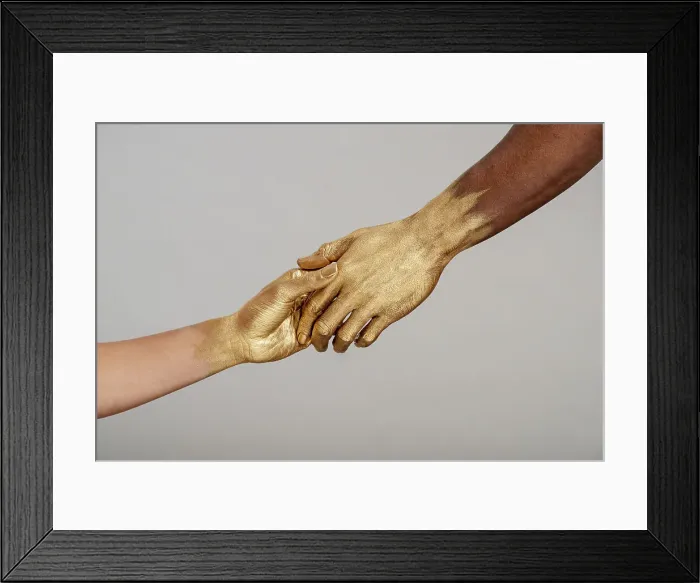 Framed Print : Yes. Detail shot of mixed-race woman and Black man with gold painted hands holding hands