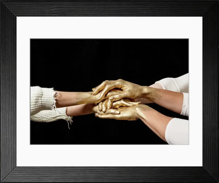 Framed Print : Yes. Close-up shot of group's gold painted hands on top of another against Framed Print : Yes. Close-up shot of group's gold painted hands on top of another against