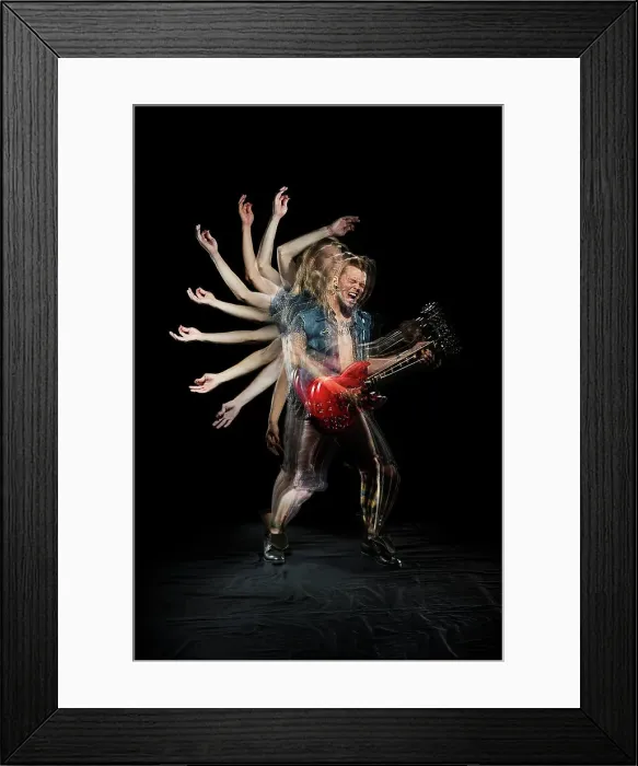 Framed Print : Stroboscopic photos of young man playing electric guitar on black background Framed Print : Stroboscopic photos of young man playing electric guitar on black background