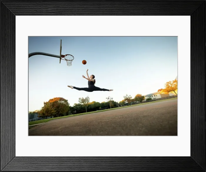 Framed Print : Ballet dancer mid-air jumping playing basketball on an outdoor court
