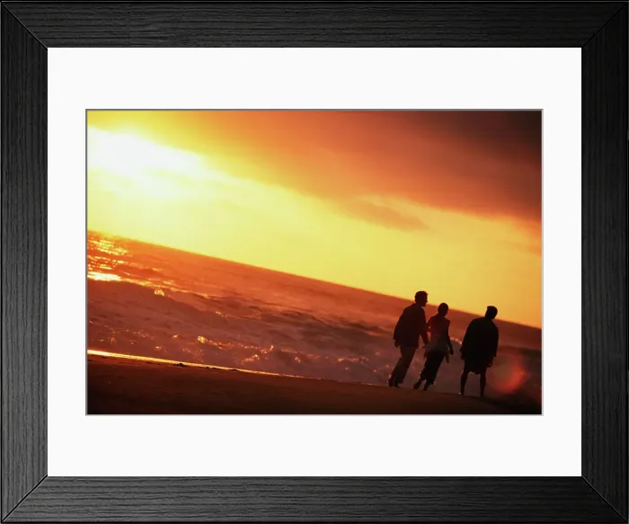 Framed Print : Three tourists walking on the beach