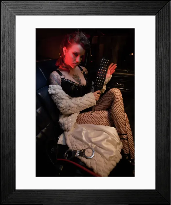 Framed Print : BLD069958. Dominatrix holding paddle in limousine Framed Print : BLD069958. Dominatrix holding paddle in limousine