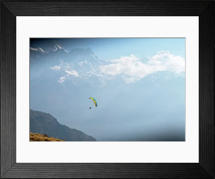 Framed Print : Wide shot of a paraglider in Nepal with mountain range in background