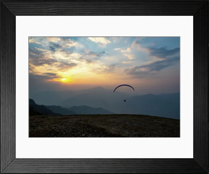 Framed Print : Paraglider taking off from cliff at sunset in Nepal