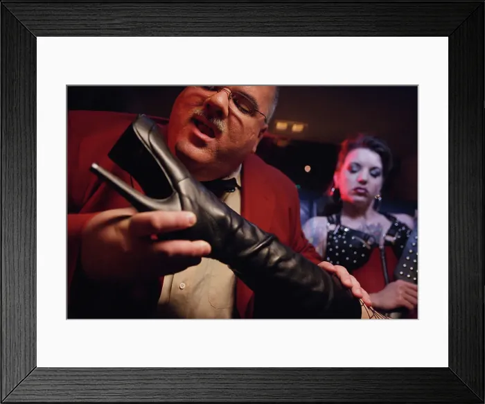 Framed Print : BLD069955. Dominatrix putting boot in man's face
