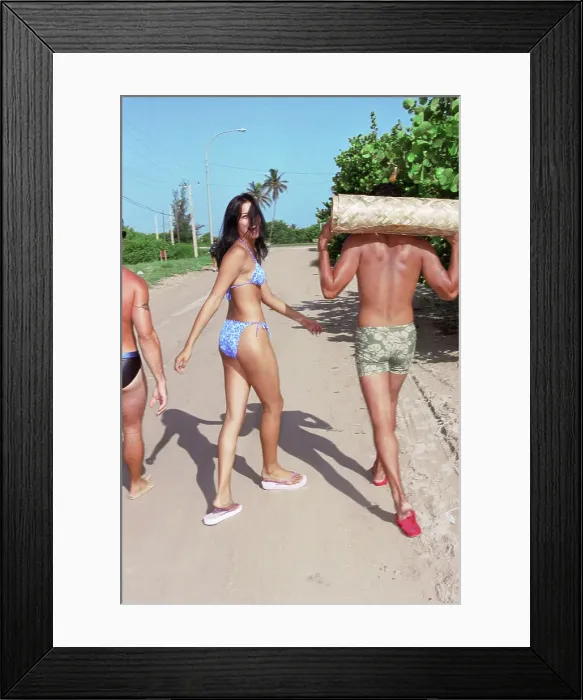 Framed Print : BLD067813. Friends in bathing suits walking on beach road Framed Print : BLD067813. Friends in bathing suits walking on beach road