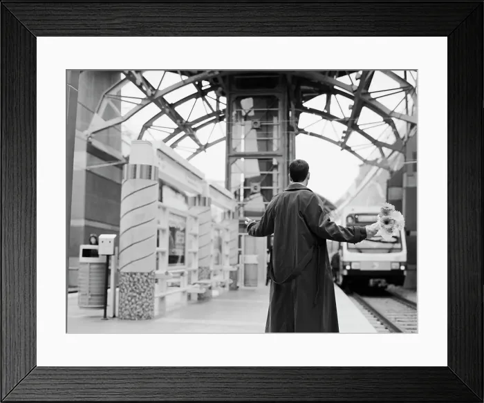 Framed Print : BLD028299. Man holding flowers with arms out at train station Framed Print : BLD028299. Man holding flowers with arms out at train station