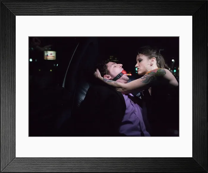 Framed Print : BLD069957. Dominatrix and man wearing ball gag in limousine Framed Print : BLD069957. Dominatrix and man wearing ball gag in limousine