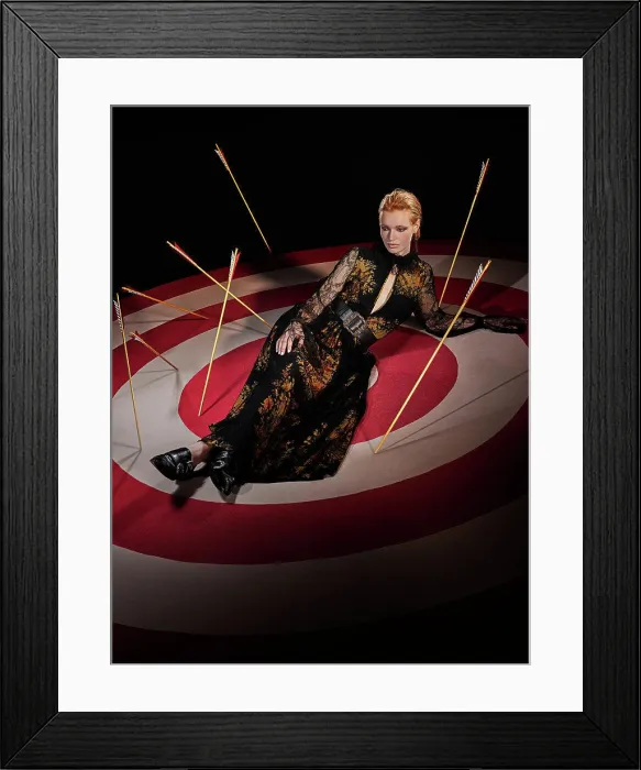 Framed Print : Portrait of a redhead woman on large hand painted Bulls-eye target with arrows