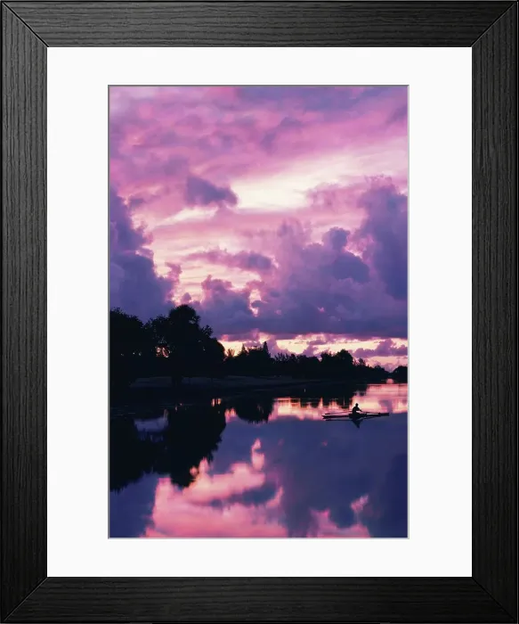 Framed Print : Silhouette of a person rowing a boat in a lake
