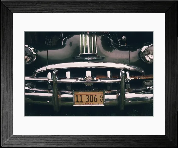 Framed Print : Front end of a classic Pontiac car with license plates