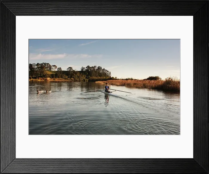 Framed Print : Rower. Lone female rower in kayak rowing on stream early in the morning Framed Print : Rower. Lone female rower in kayak rowing on stream early in the morning