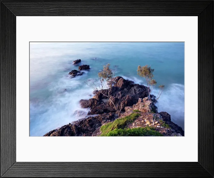 Framed Print : Waves washing over rocks