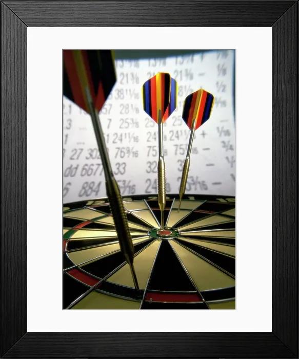 Framed Print : Darts on a dartboard with stock figures in the background Framed Print : Darts on a dartboard with stock figures in the background