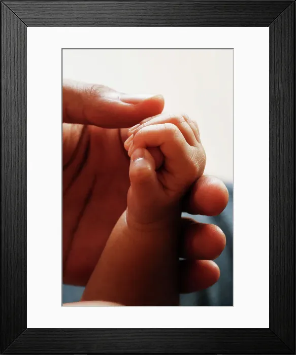 Framed Print : BLD013407. Close up of baby's hand holding adult's hand Framed Print : BLD013407. Close up of baby's hand holding adult's hand