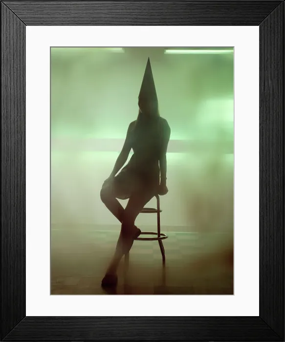 Framed Print : Silhouette of a woman wearing a dunce cap and sitting on a bar stool Framed Print : Silhouette of a woman wearing a dunce cap and sitting on a bar stool