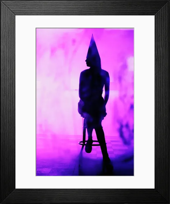 Framed Print : Silhouette of a woman wearing a dunce cap and sitting on a bar stool Framed Print : Silhouette of a woman wearing a dunce cap and sitting on a bar stool