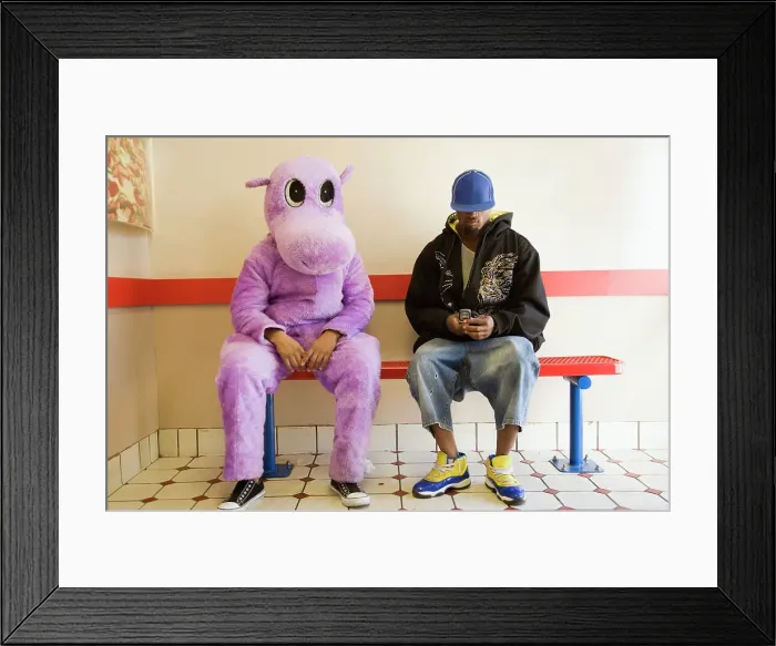Framed Print : Person in hippo costume sitting next to a man text messaging on a mobile phone Framed Print : Person in hippo costume sitting next to a man text messaging on a mobile phone