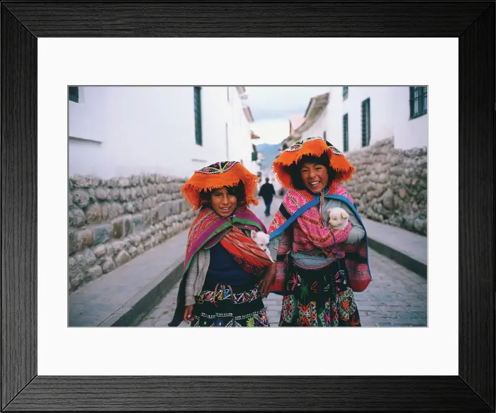 Framed Print : Two girls standing in the street holding two puppies Framed Print : Two girls standing in the street holding two puppies
