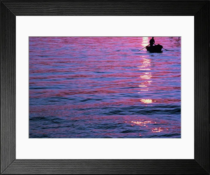 Framed Print : Silhouette of a person in boat at sunset Framed Print : Silhouette of a person in boat at sunset