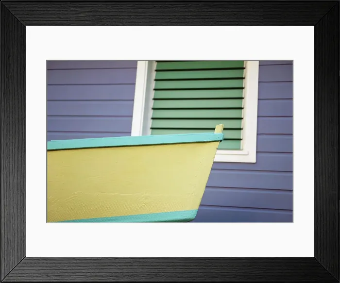 Framed Print : Close-up of bow of a boat in front of a shuttered window