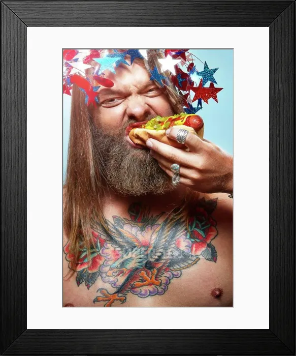 Framed Print : Portrait of a man dressed up for the 4th of July eating a hotdog Framed Print : Portrait of a man dressed up for the 4th of July eating a hotdog