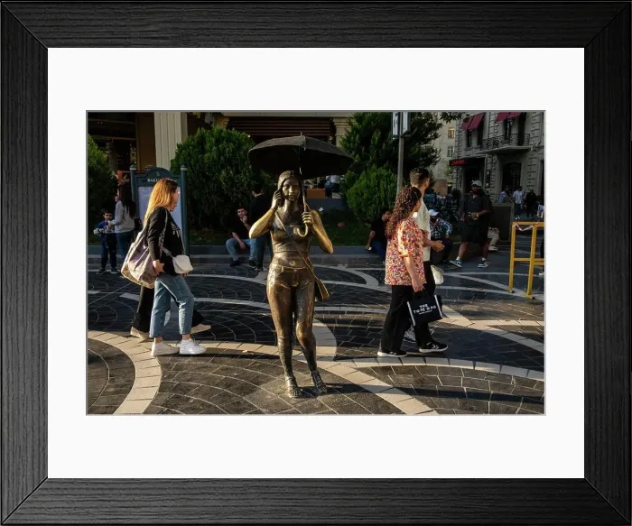 Framed Print : Baku, Azerbaijan Sept 22, 2024 Pedestrians pass a sculpture called Girl with Umbrella on Nizami Street Framed Print : Baku, Azerbaijan Sept 22, 2024 Pedestrians pass a sculpture called Girl with Umbrella on Nizami Street