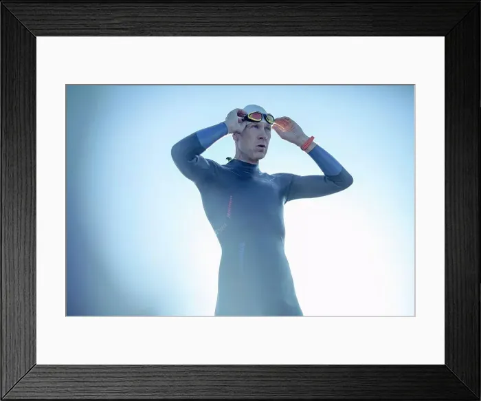 Framed Print : A swimmer in a wetsuit and swimming hat, adjusting his swimming goggles Framed Print : A swimmer in a wetsuit and swimming hat, adjusting his swimming goggles