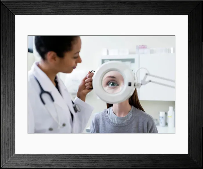 Framed Print : Doctor giving patient eye test