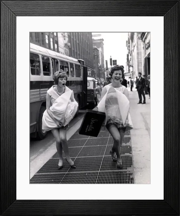 Framed Print : Young women in dresses surprised by gust of air Framed Print : Young women in dresses surprised by gust of air
