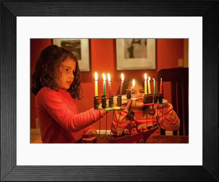 Framed Print : Two young girls lighting Chanukah candles Framed Print : Two young girls lighting Chanukah candles