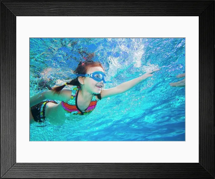 Framed Print : Underwater shot of Asian girl swimming Framed Print : Underwater shot of Asian girl swimming