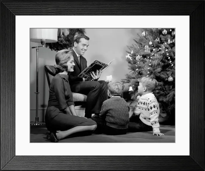 Framed Print : 1960S Family Father Mother Two Sons Smiling Sitting By Christmas Tree In Living Room Reading A Book
