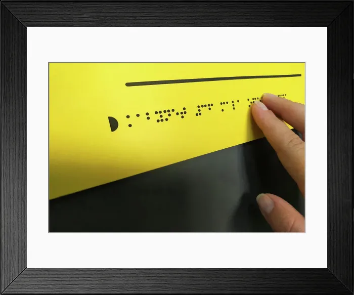 Framed Print : Woman hand reading braille text Framed Print : Woman hand reading braille text