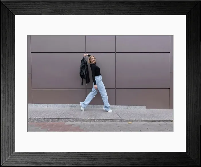 Framed Print : Woman walks in front of a gray wall Framed Print : Woman walks in front of a gray wall
